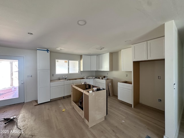 3725 E Karen Dr, Phoenix, AZ 85032 - kitchen featuring light wood finished floors, a center island, and white cabinets