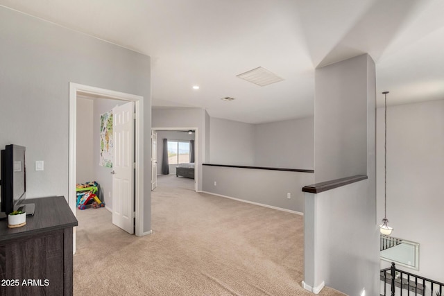 hallway with visible vents, baseboards, recessed lighting, light carpet, and an upstairs landing