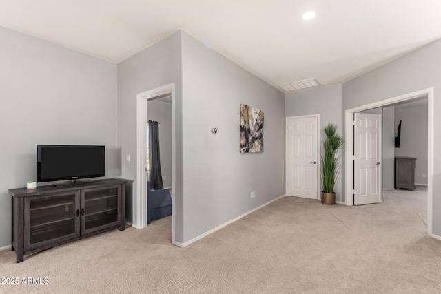 hallway with visible vents, baseboards, and carpet floors