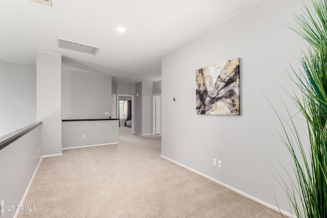 carpeted empty room with recessed lighting, visible vents, and baseboards