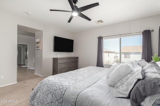 carpeted bedroom featuring visible vents, a ceiling fan, and baseboards