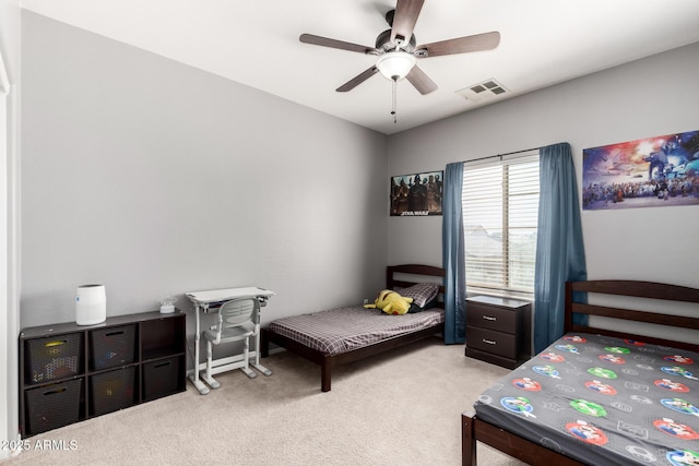 carpeted bedroom featuring visible vents and a ceiling fan