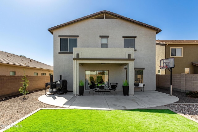 back of property featuring a patio area, a fenced backyard, a lawn, and stucco siding