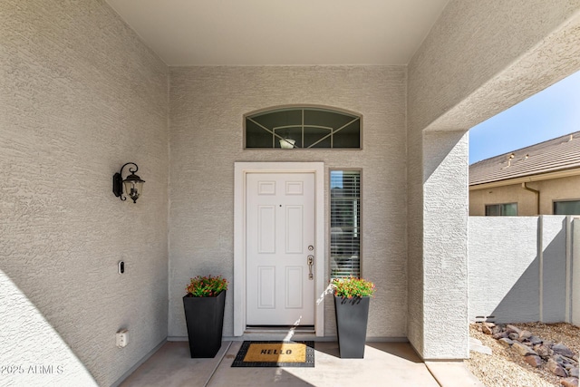 view of exterior entry with stucco siding