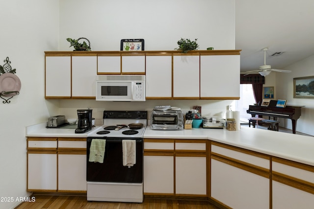 kitchen featuring white cabinetry, ceiling fan, electric range oven, and light hardwood / wood-style flooring