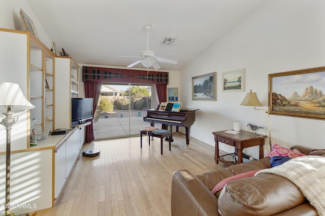 living area with ceiling fan, high vaulted ceiling, and light hardwood / wood-style floors