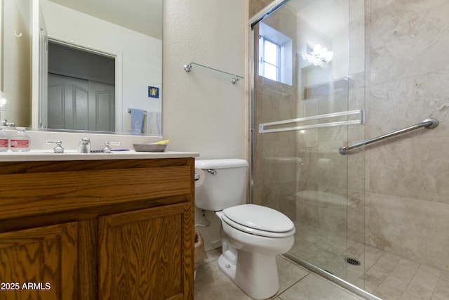 bathroom featuring vanity, a shower with shower door, tile patterned floors, and toilet