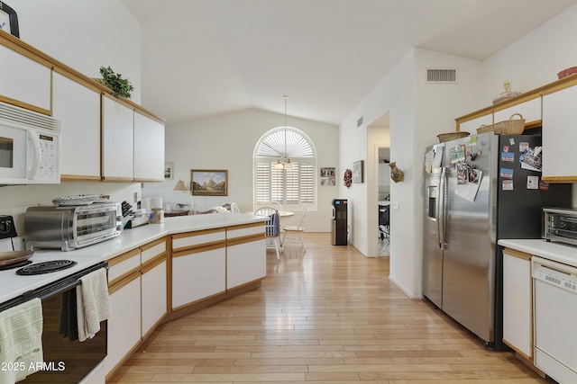 kitchen with pendant lighting, white cabinets, white appliances, and light hardwood / wood-style flooring