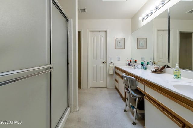 bathroom with vanity and a shower with shower door