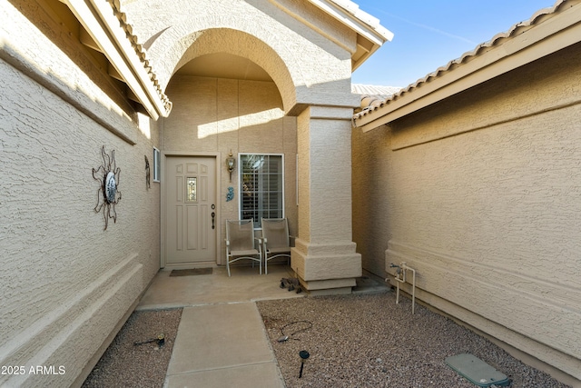 doorway to property with a patio area