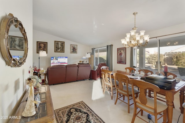 dining room featuring lofted ceiling, carpet flooring, and a chandelier