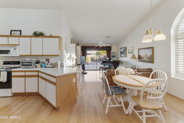 kitchen featuring white cabinets, decorative light fixtures, light hardwood / wood-style flooring, and electric range