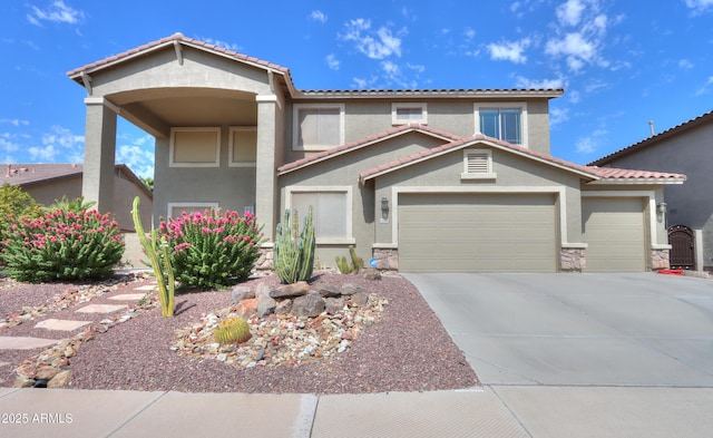 view of front of home featuring a garage, concrete driveway, a tiled roof, and stucco siding