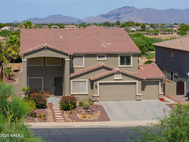 mediterranean / spanish house with a tile roof, a gate, a mountain view, and stucco siding