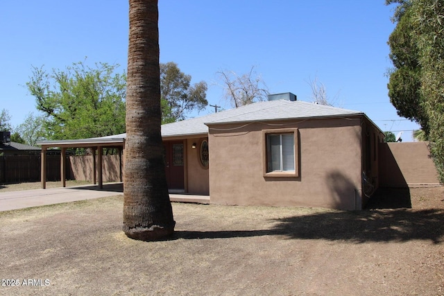 rear view of property with a carport