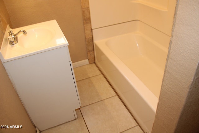 bathroom featuring vanity, a tub to relax in, and tile patterned floors