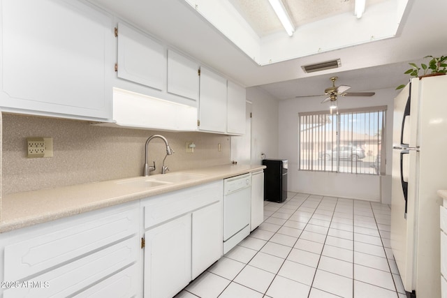 kitchen with white cabinetry, sink, white appliances, and tasteful backsplash