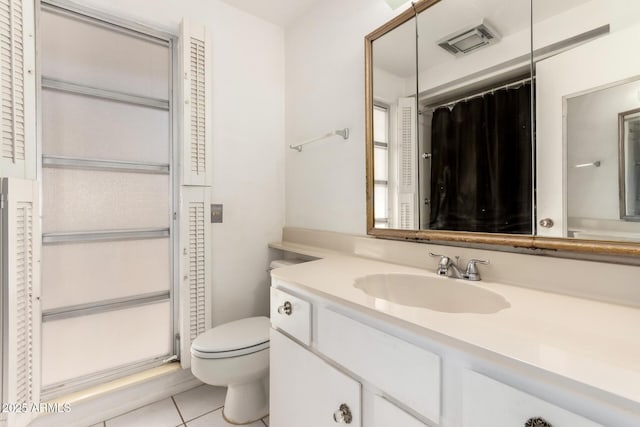 bathroom with walk in shower, vanity, toilet, and tile patterned flooring