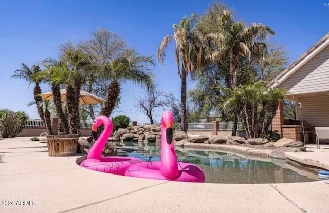 view of property's community with a patio area and a pool