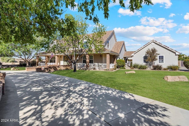 view of front of home with a porch and a front lawn