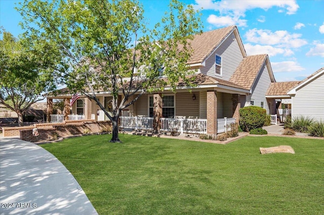 view of front of property featuring covered porch and a front yard