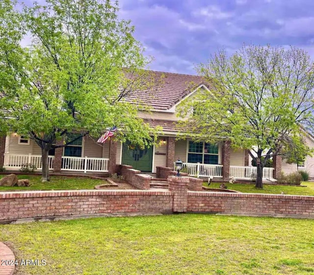 view of front of home with a front yard and covered porch