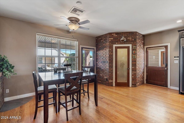 dining room with light hardwood / wood-style floors and ceiling fan