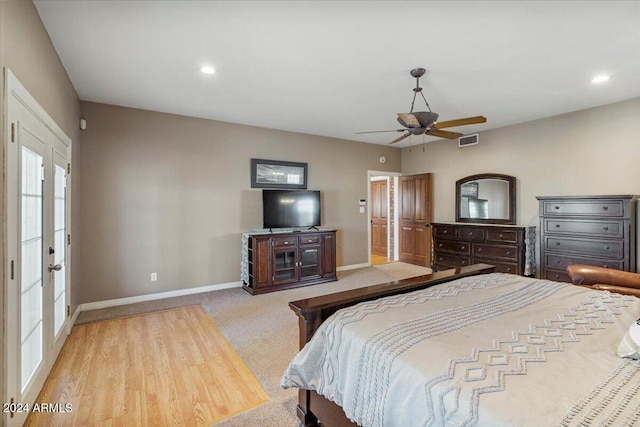 bedroom with french doors, light carpet, and ceiling fan