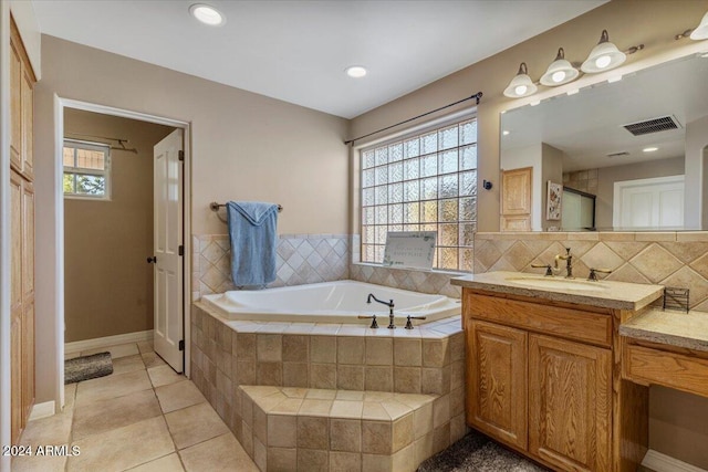 bathroom with vanity, tile patterned flooring, decorative backsplash, and tiled tub