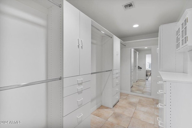 walk in closet with light tile patterned floors