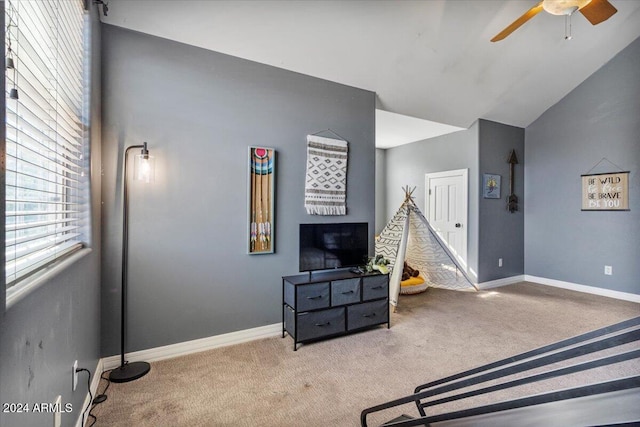 interior space with lofted ceiling and ceiling fan