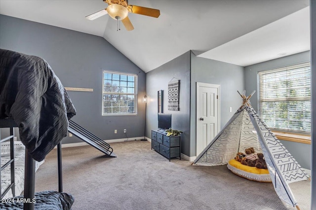 rec room featuring lofted ceiling, light carpet, and ceiling fan