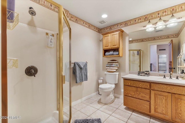 bathroom with vanity, tile patterned flooring, toilet, and an enclosed shower