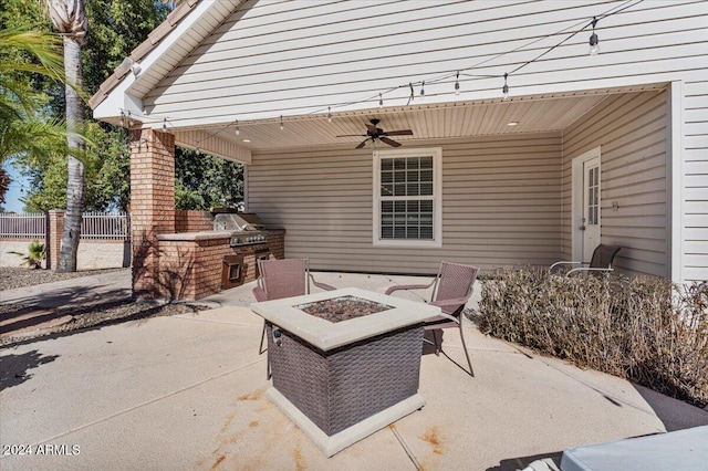 view of patio featuring ceiling fan, area for grilling, and a fire pit