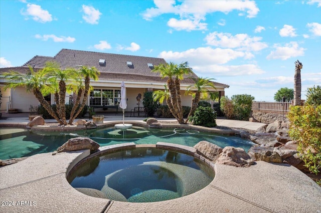 view of pool featuring a patio area and an in ground hot tub