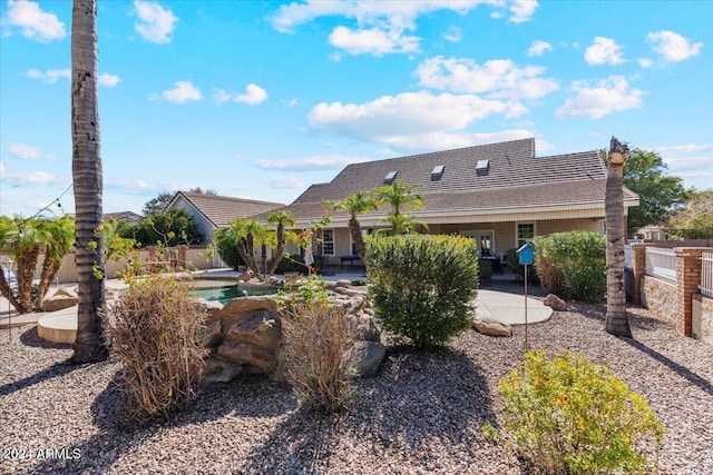 back of house with a patio area and a pool