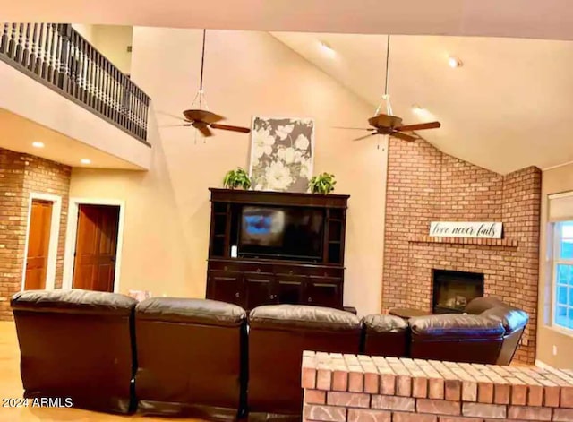 living room featuring high vaulted ceiling, ceiling fan, and a brick fireplace