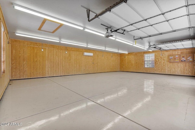 garage featuring a garage door opener and wooden walls