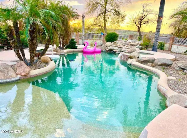 view of pool at dusk