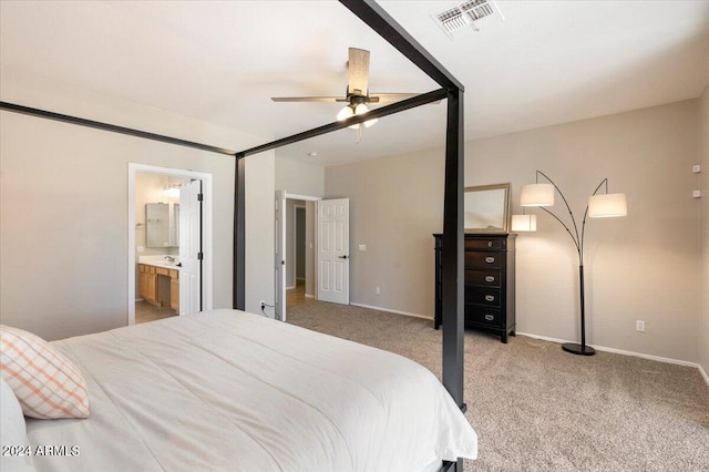 carpeted bedroom with connected bathroom and ceiling fan