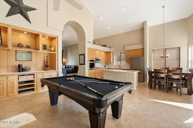 rec room with pool table, high vaulted ceiling, built in shelves, and sink