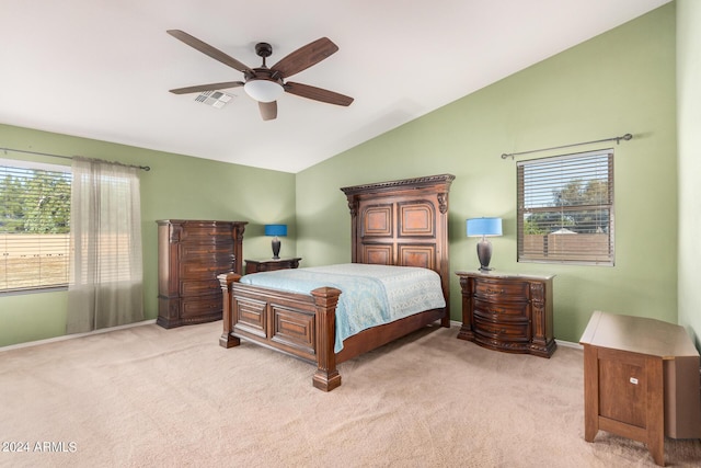 carpeted bedroom featuring multiple windows, ceiling fan, and lofted ceiling