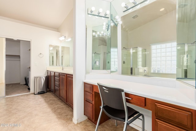 bathroom with tile patterned flooring, vanity, a shower with shower door, and lofted ceiling