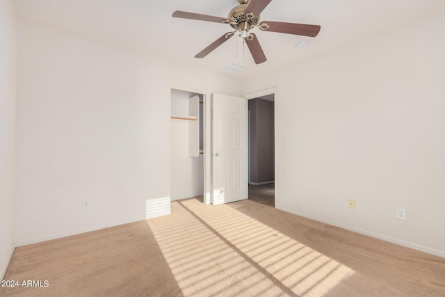 carpeted spare room with ceiling fan