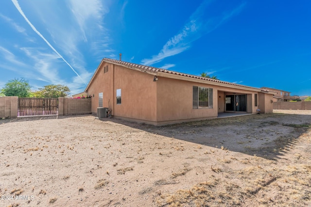 back of property with central AC