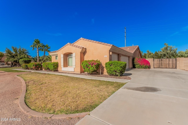 view of front of house with a garage and a front lawn