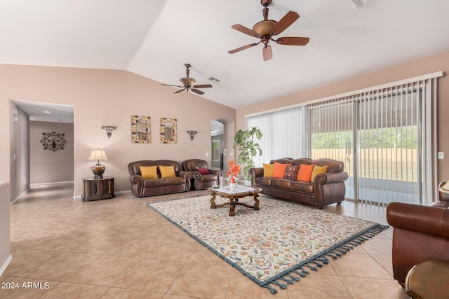 living room featuring ceiling fan, light tile patterned floors, and vaulted ceiling