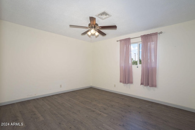 unfurnished room with ceiling fan and dark hardwood / wood-style floors