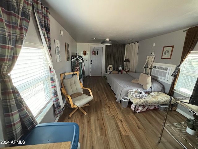 living room featuring hardwood / wood-style floors and a wall unit AC