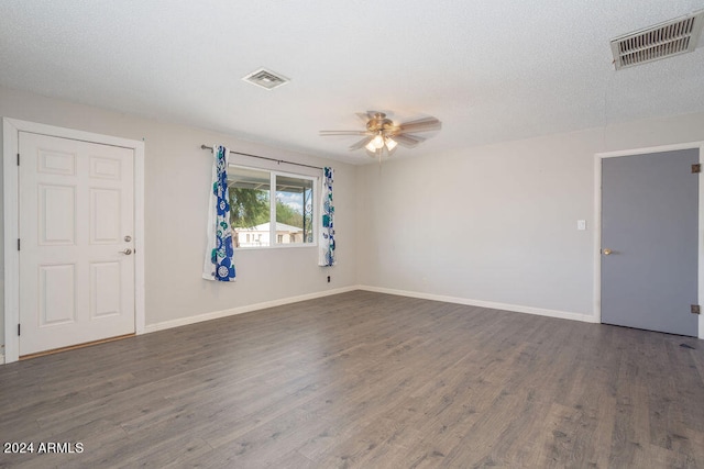 unfurnished room with hardwood / wood-style floors, ceiling fan, and a textured ceiling